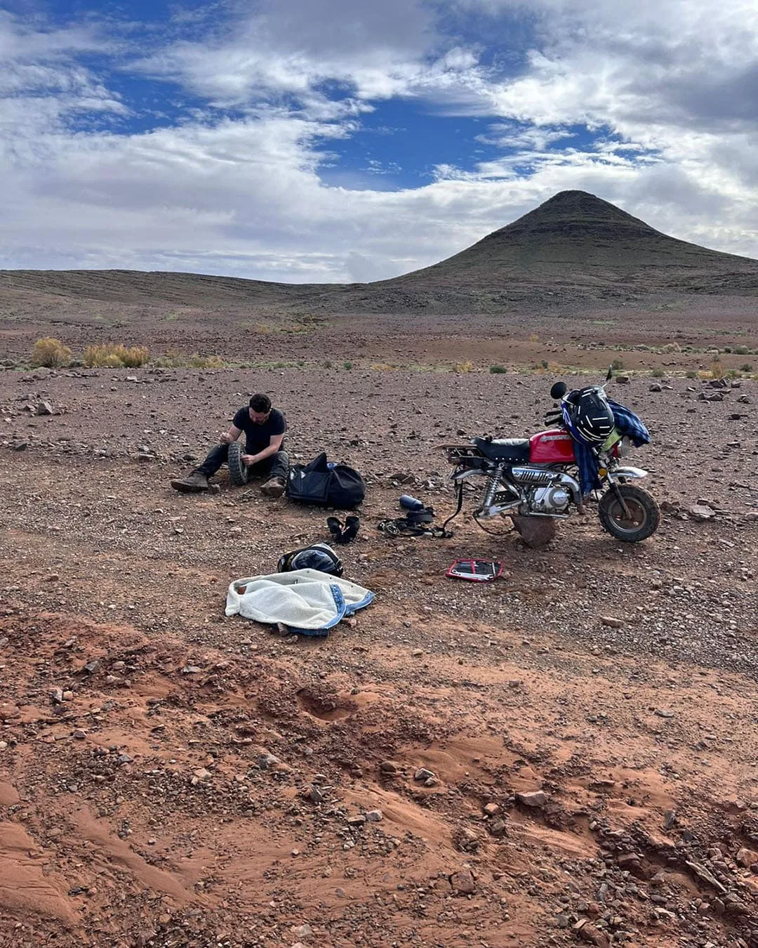 Josh Hannagan repairing his bike in the middle of nowhere, Monkey Run Morocco October 2024.